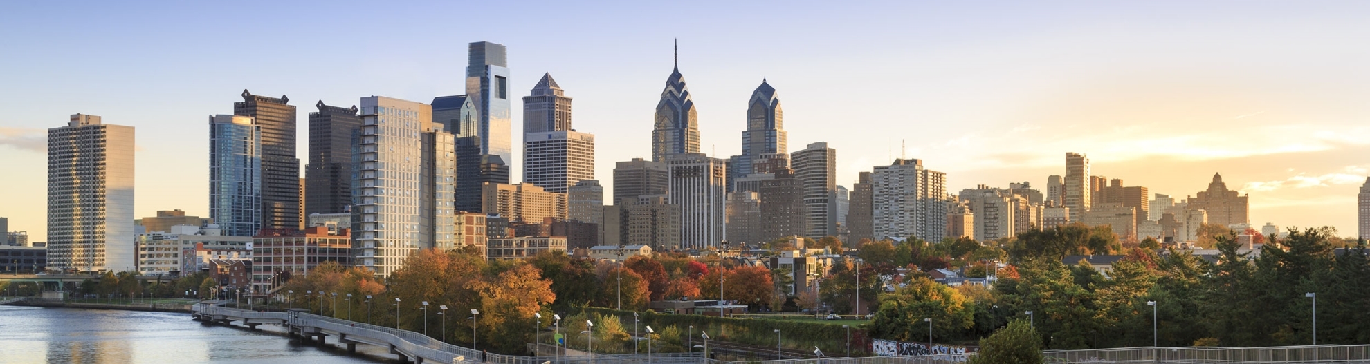 Skyline in autumn behind the Schuylkill River Boardwalk at dawn , Philadelphia, Pennsylvania, USA